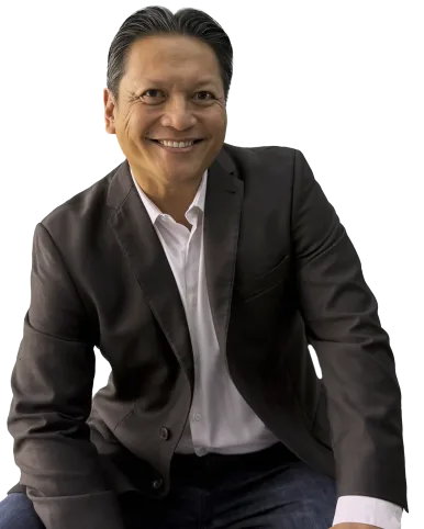 Jonathan Engalla seated and smiling during leadership coaching session