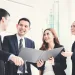 Asian,Business,Team,Discussing,Work,In,Building,Hallway