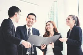 Asian,Business,Team,Discussing,Work,In,Building,Hallway